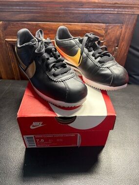 Nike Kids Black Sneakers with Gold Swoosh